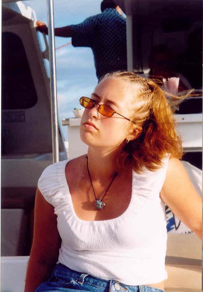 looking particularly bored and sunburned on a boat